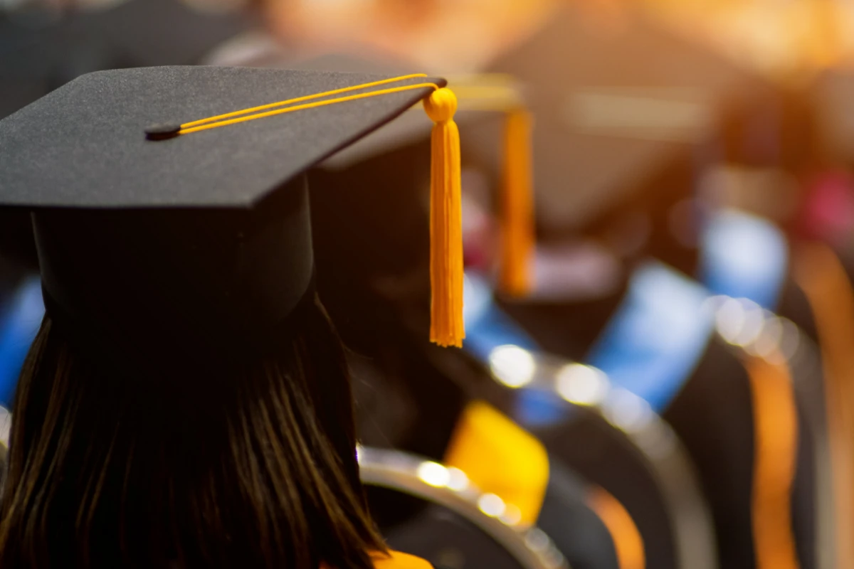 Students in queue with convocation caps
