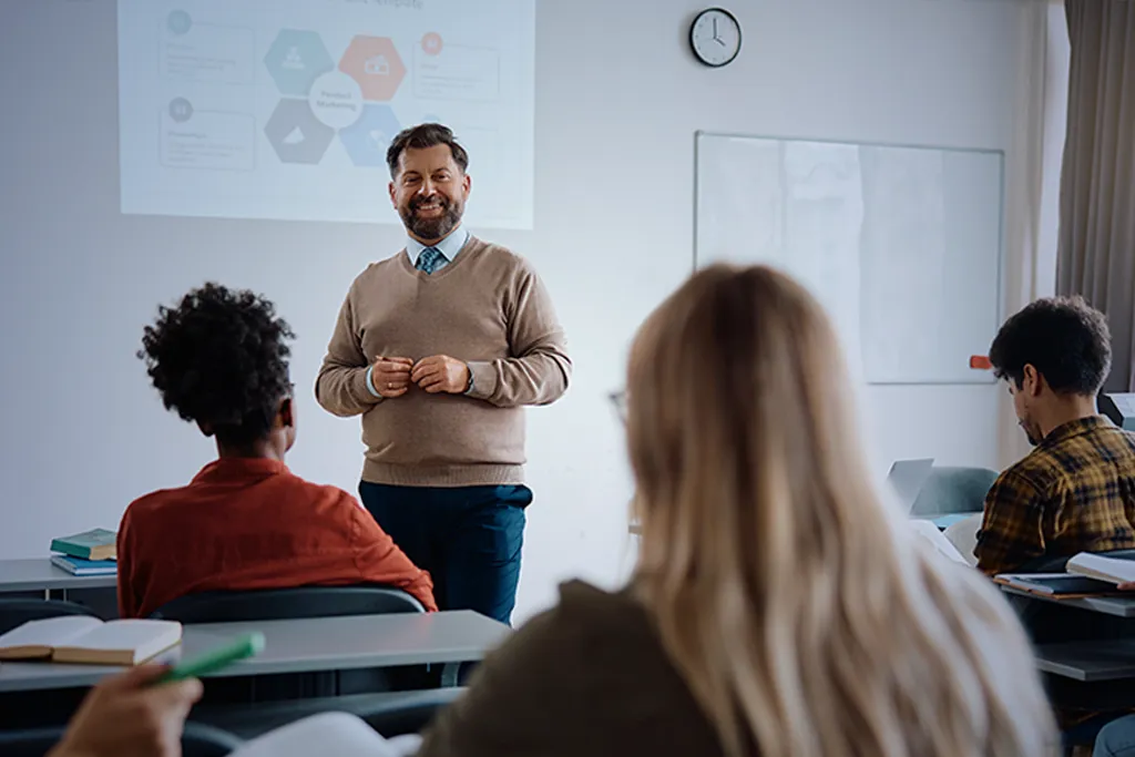 A professor leading a finance lecture, engaging students with CFA-aligned course materials.
